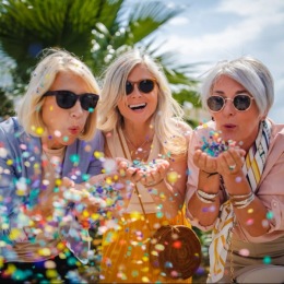 The essence of exceptional living a group of people blowing confetti