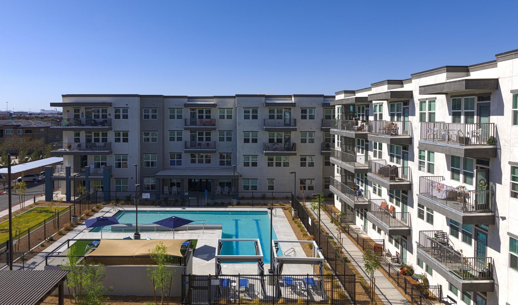 Shimmering resort-style pool a building with a pool