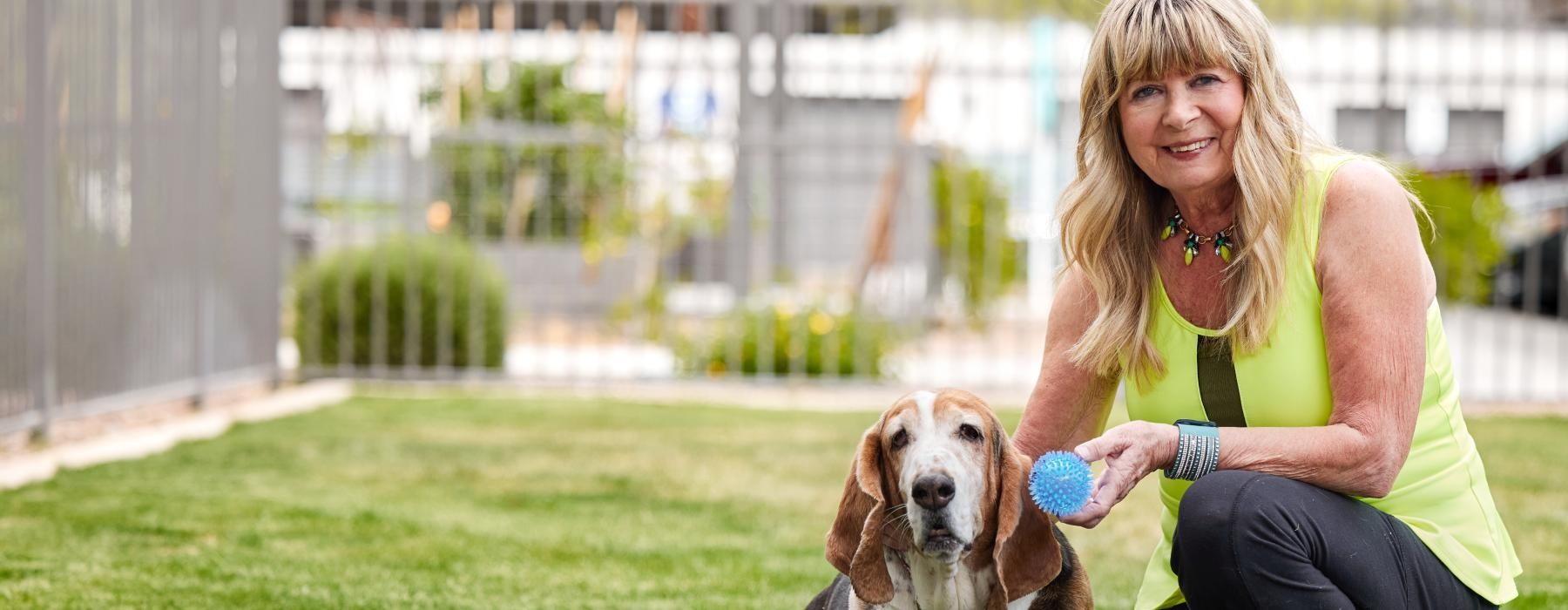 a woman sitting with a dog
