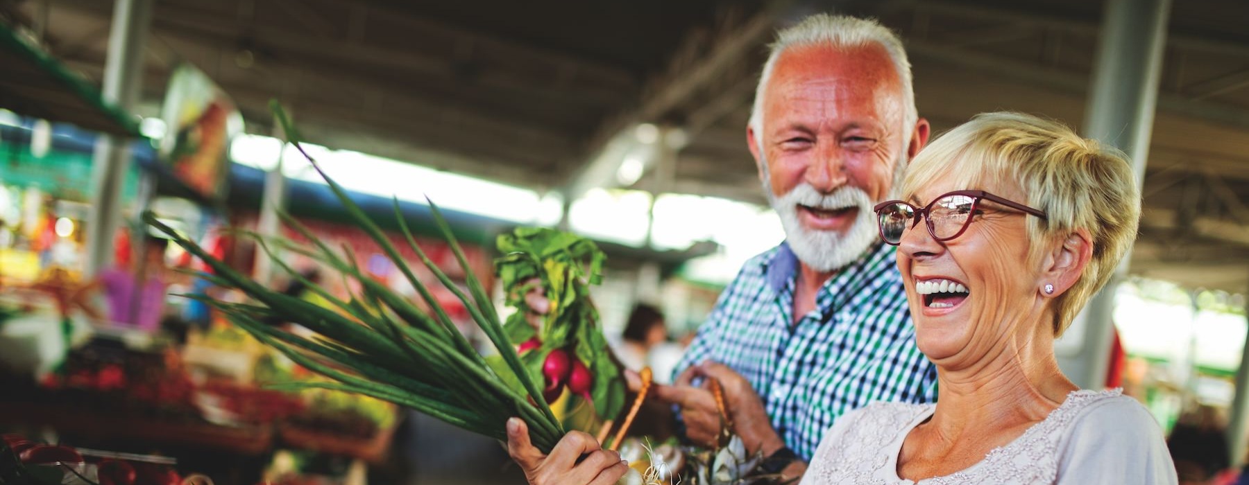 Close to the center of everything a man and woman holding a basket of vegetables